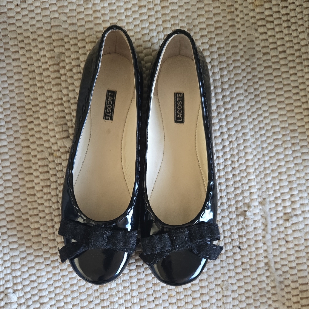 LACOSTE Glossy Black Flats with Rounded Toe and Decorative Bow